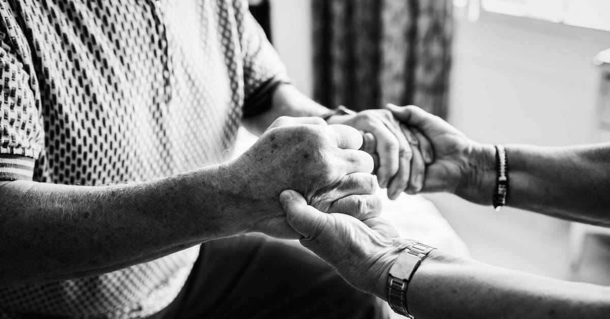 senior hand support caring team